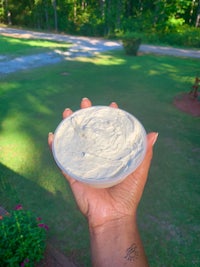 a person holding a bowl of whipped cream